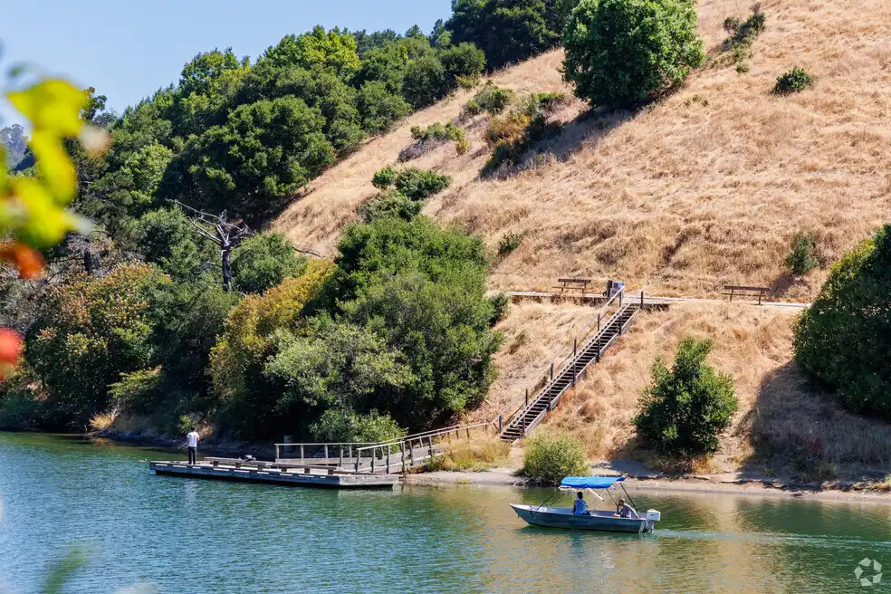 Hillside with wooden staircase leading to dock and boats on river, Five Canyons Castro Valley