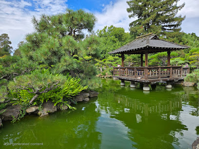 Japanese garden with pond, pavilion, and lush green landscaping