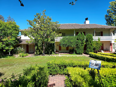 Residential home with manicured landscaping and Fito Plumbers sign in front yard