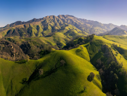 Aerial view of rolling green hills and mountains in Livermore area
