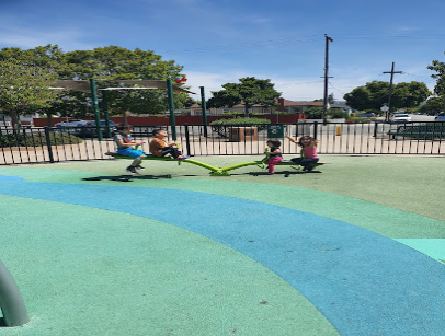 Colorful playground surface with children playing in a park on a sunny day