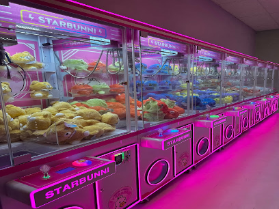 Starbunni arcade claw machine games with neon pink lighting and plush prizes