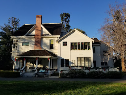 Cream-colored two-story residential home with brick chimney and front porch, typical of Fito Plumbers' service area