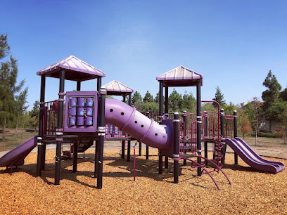 Purple playground structure with slides and climbing features in park setting